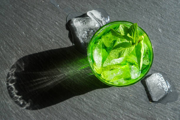 istock Delicious drink witn ice and mint on a black stone background. 1224396542