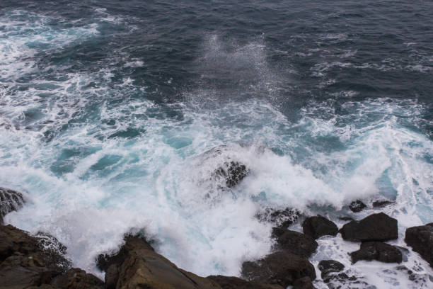 istock Splashing waves rolled on stones in a stormy sea 1224397109