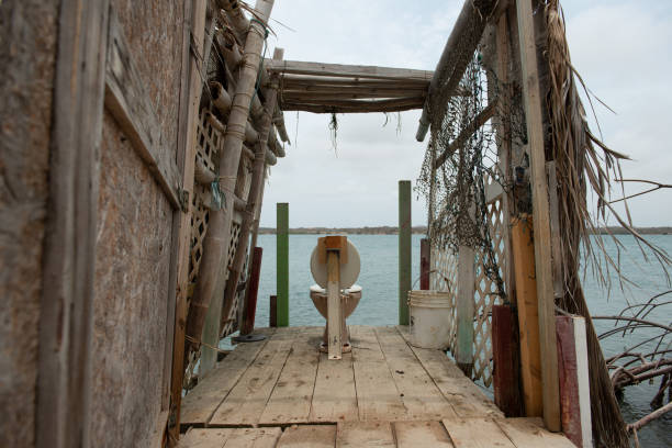 Toilet on a jetty overlooking the sea. Toilet house is built of bamboo, natural toilet outdoors.