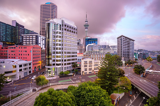 Aerial cityscape image of Auckland skyline, New Zealand during summer sunrise.