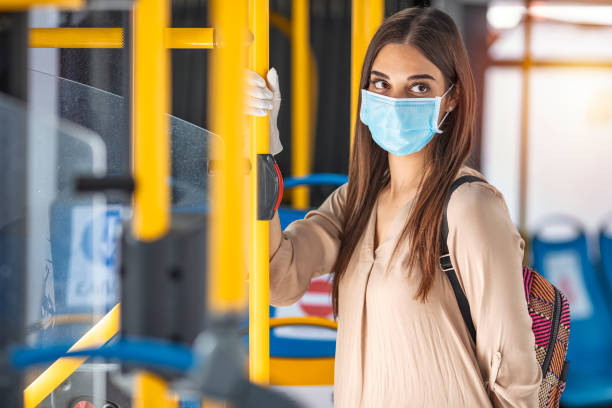 Woman wearing surgical protective mask going to work.