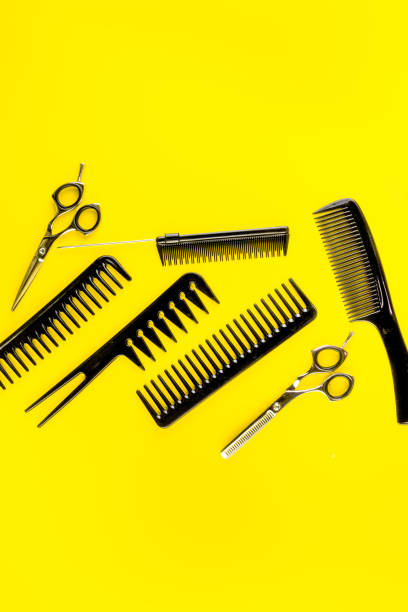 istock Combs, hairbrush, scissors on yellow desk from above copy space 1224402620