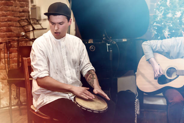 istock stylish percussionist playing on leather drum on a concert, hands motion 1224402712