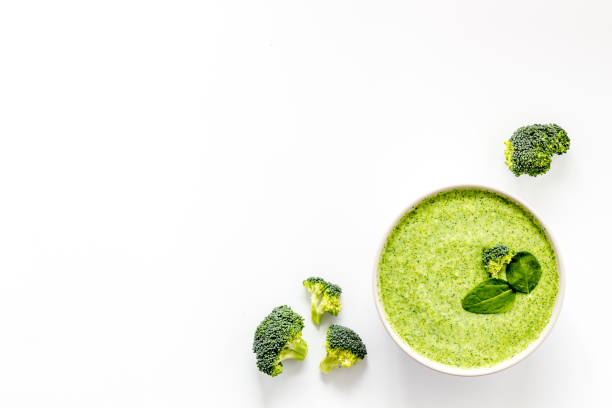 istock Broccoli vegan cream soup in bowl on white table from above copy space 1224402713