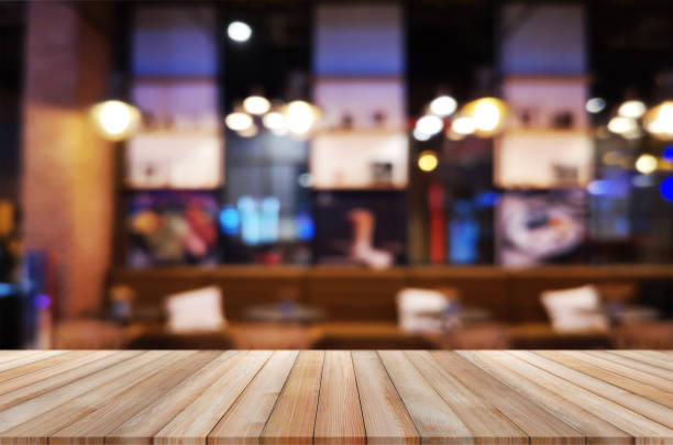istock wooden table with abstract blurred background resturant lights used for display montage products mock up design. 1224402736