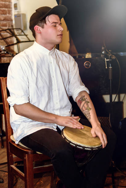istock stylish percussionist playing on leather drum on a concert, hands motion 1224402758