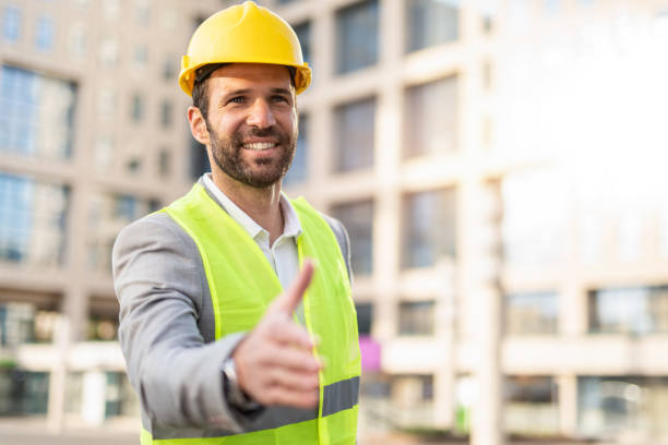 istock Happy mid adult engineer shaking hands. 1224404405