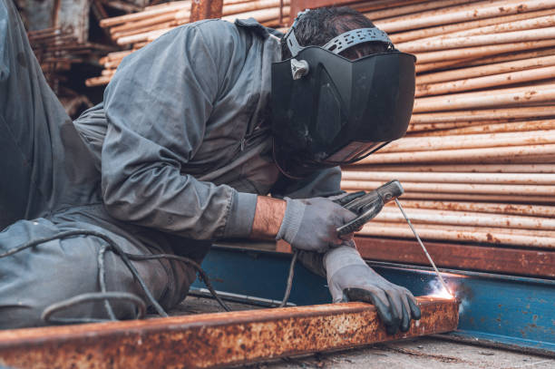 istock Welding work, Man Welding in Workshop. Metalwork and Sparks. Construction and Industrial concept. 1224404498