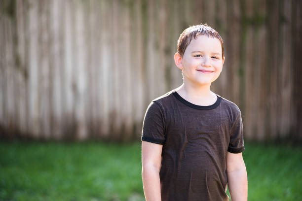 istock Happy boy playing in sprinkler 1224406027