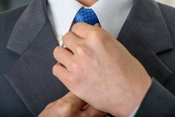 istock Male hands adjusting necktie knot. 1224407754