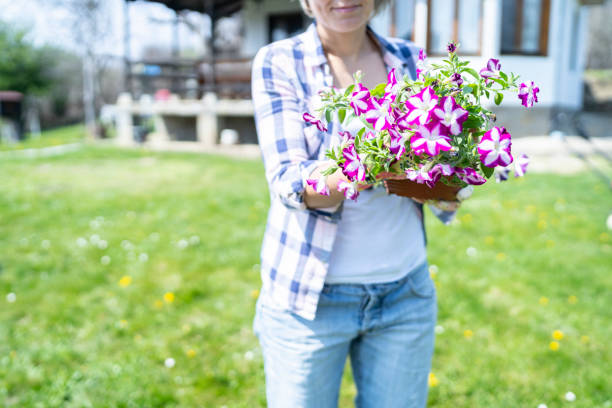 istock Woman holding spring flowers 1224408089