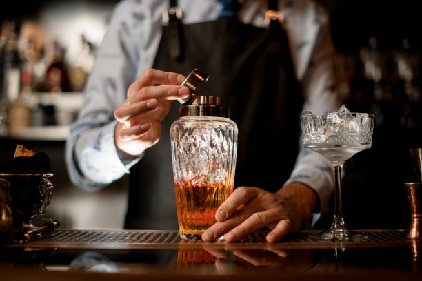 istock Close-up glass shaker with brown alcoholic drink and ice. 1224410851