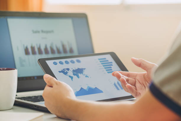 istock businessman working on project for analyzing company financial report balance statement with documents graphics at modern office space. Concept picture of business,economy, market,money and tax. 1224410967