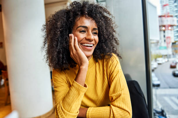 istock Young African woman sitting alone in a cafe 1224411906