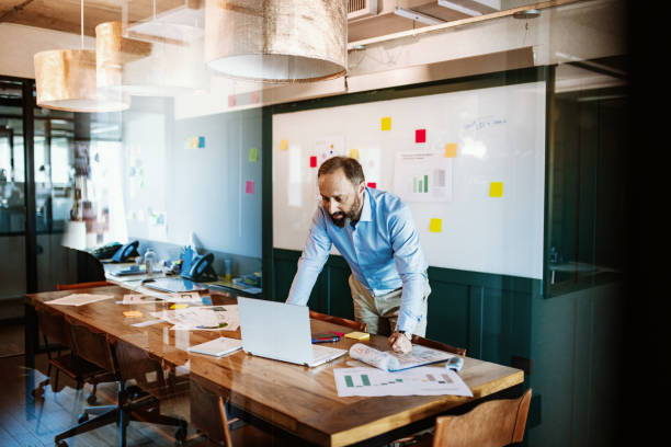 istock Businessman in blue shit in board room 1224412031