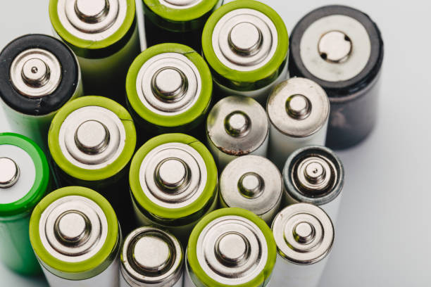 istock many new and used alkaline batteries type AA on a light background. 1224412058