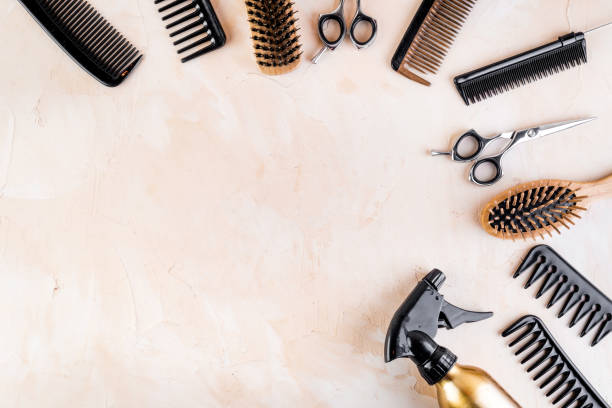 istock Hairdressing instruments. Combs, scissors and spray on beige desk from above frame space for text 1224412206