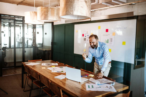 istock Businessman in empty office attending video conference with remote colleagues 1224412301