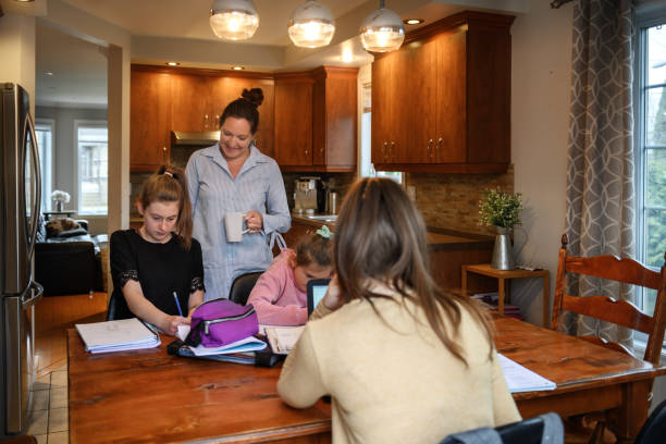 istock Mother Helping To Her Daughters To Finish School Homework During Coronavirus Quarantine 1224413317