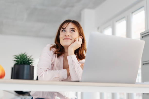 istock Young businesswoman sitting daydreaming 1224414106