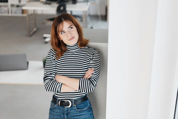 istock Thoughtful young woman standing looking up 1224414361