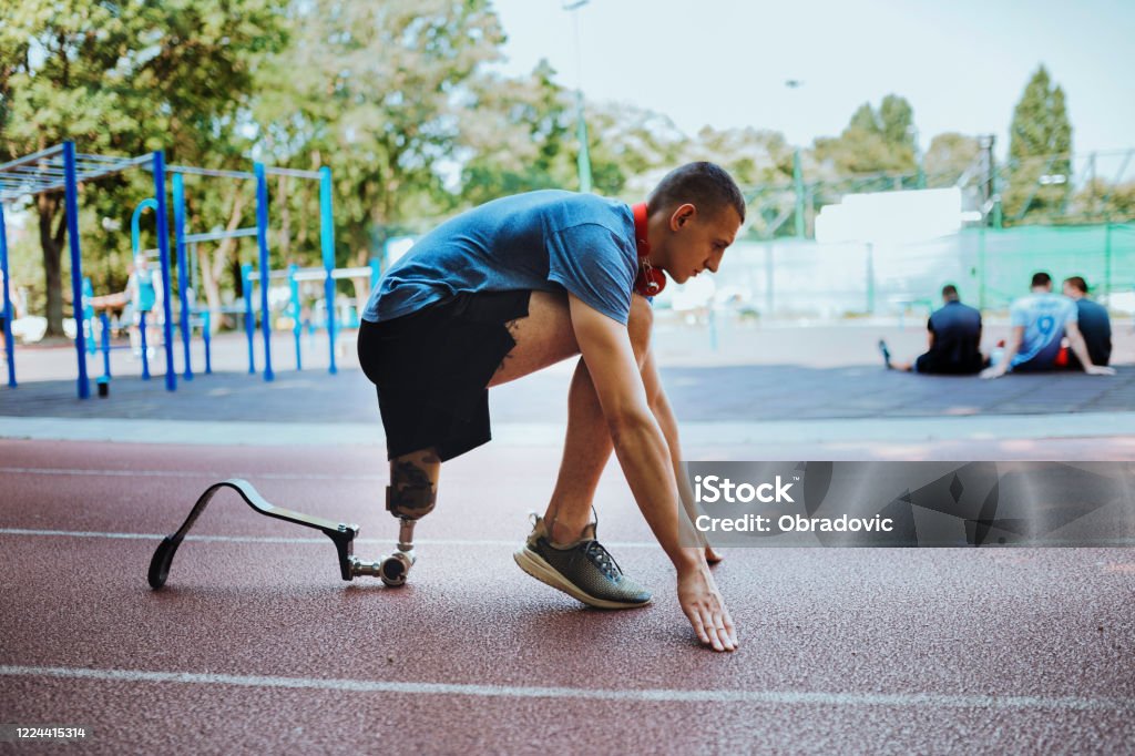 Man with prosthetic leg on running outdoors disability Disability Stock Photo