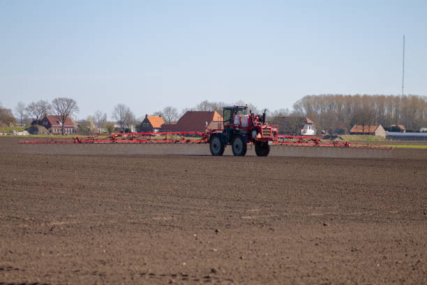 istock sprinkler spray beam tractor rides across the meadow 1224415550