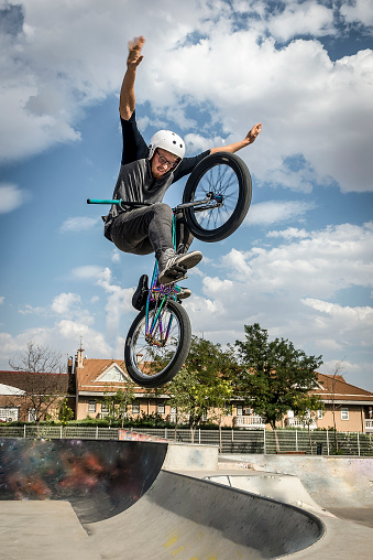 Young man doing street tricks with a bmx. Extreme urban sports concept