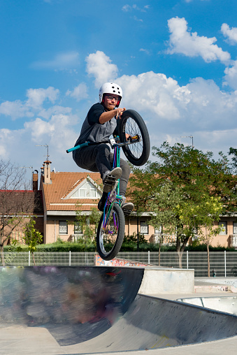 Young man doing street tricks with a bmx. Extreme urban sports concept