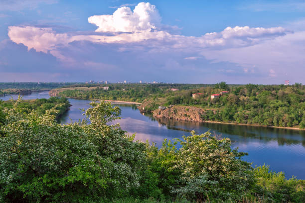 istock Beautiful spring landscape with river, blooming trees, lush forest and cliffs 1224415728