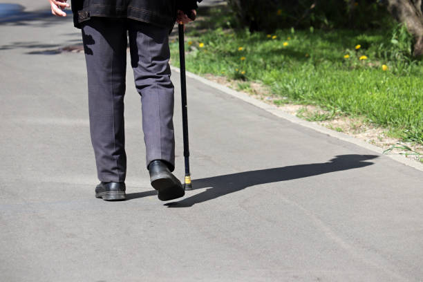 istock Man walks with a cane on a city street 1224416651