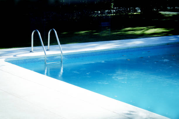 istock Summer pool surrounded by grass. No people 1224418211