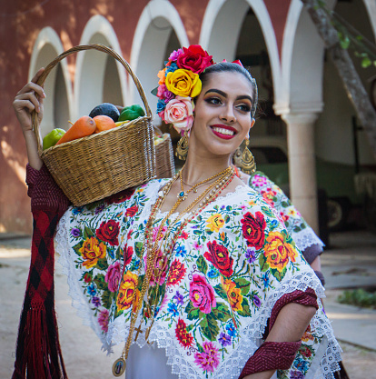 Young woman dancing with traditional Mexican clothing dancing outdoors