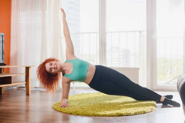 istock Girl in side plank with hand up 1224420176