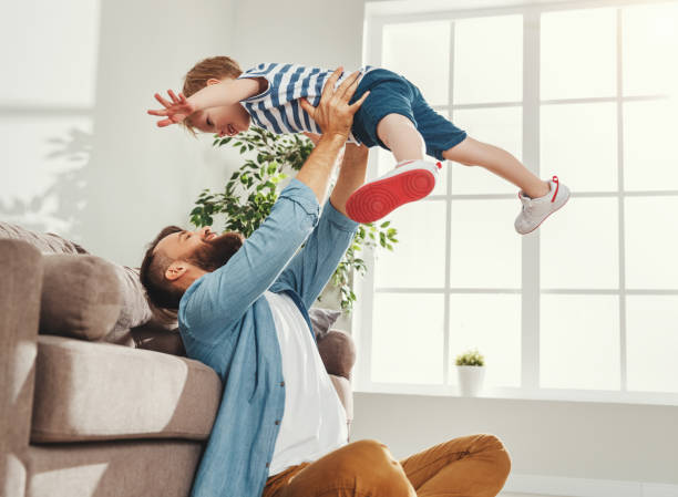 istock Cheerful father playing with kid at home 1224421030
