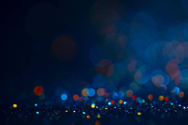 istock Decoration bokeh lights background, abstract sparkle backdrop with circles,modern design wallpaper with sparkling glimmers. Black, blue and golden backdrop glittering sparks with glow effect. 1224421210