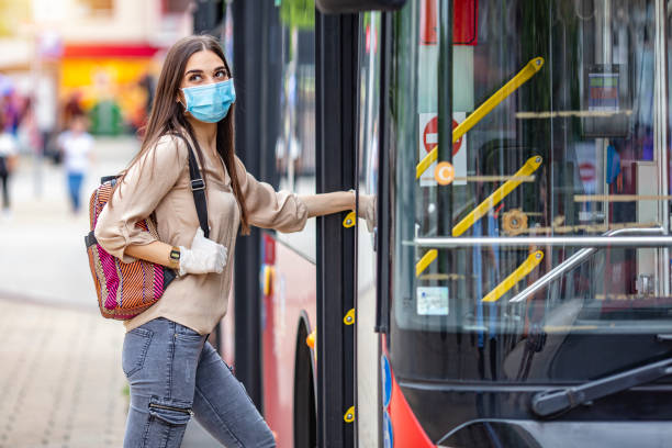 istock Young traveler boarding a bus with a protective mask. 1224423096