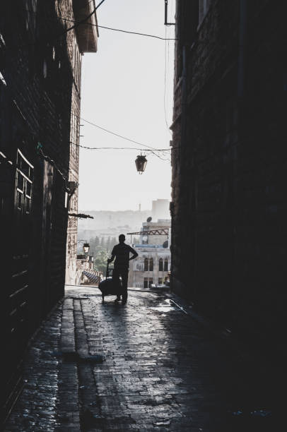 A man pushes a dolly on a street in Aleppo, Syria. (June 23, 2010)