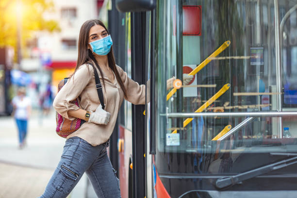Young female boarding a city bus.