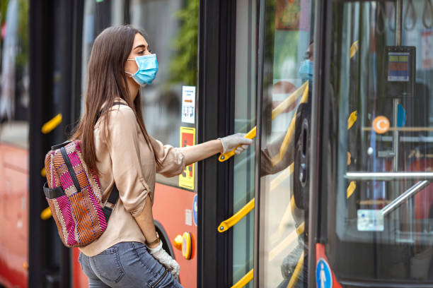istock Young traveler boarding a bus with a protective mask. 1224423257