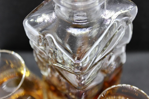 Whisky and cognac in glasses together with a decanter