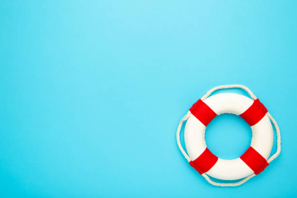 istock Red-white lifebuoy on blue background. Copy space 1224427780