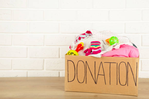 istock Donation box with baby clothes on light background 1224427962