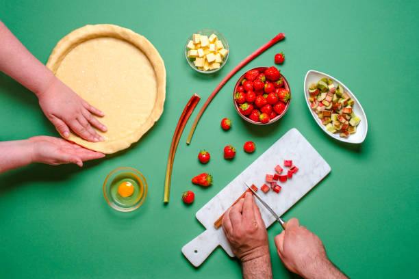 istock Making a pie top view. Young couple home baking 1224429377