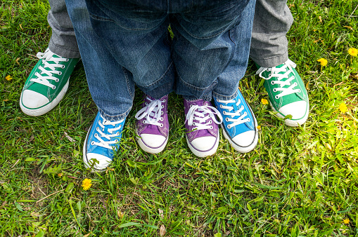 Family legs on green grass