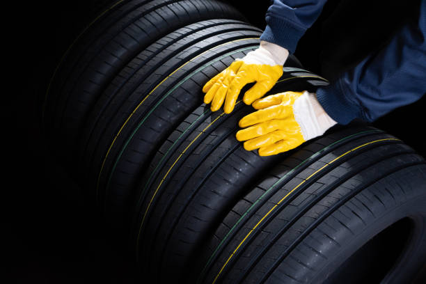 istock New tires at the storage. Worker takes a tyre. 1224433772