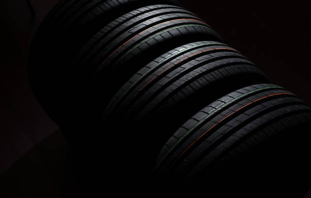 istock Beautiful background with new tires on a dark backdrop 1224434433