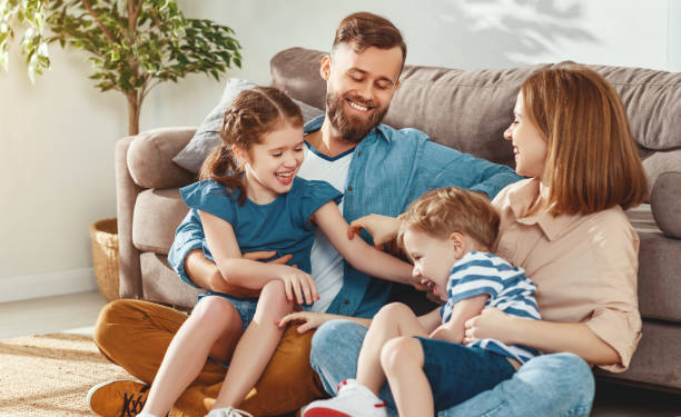 istock Cheerful parents with kids having fun at home 1224435839