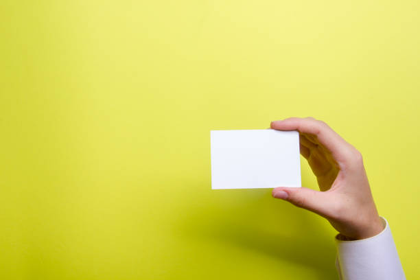 istock Hand holding white business card on white background 1224437571