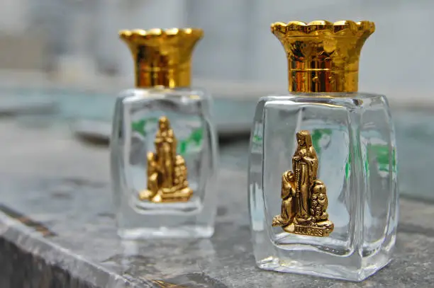 Small bottles to take away holy water with the Virgin Lourdes’s image